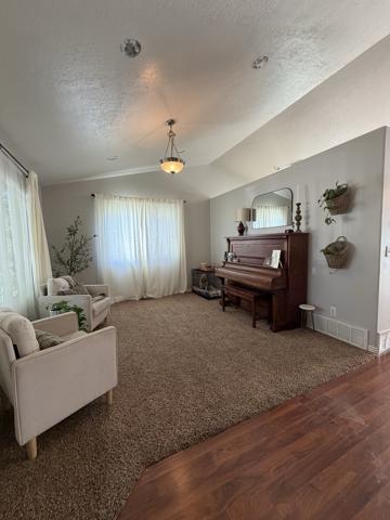 Living room before recessed can lighting, lit only by a single pendant